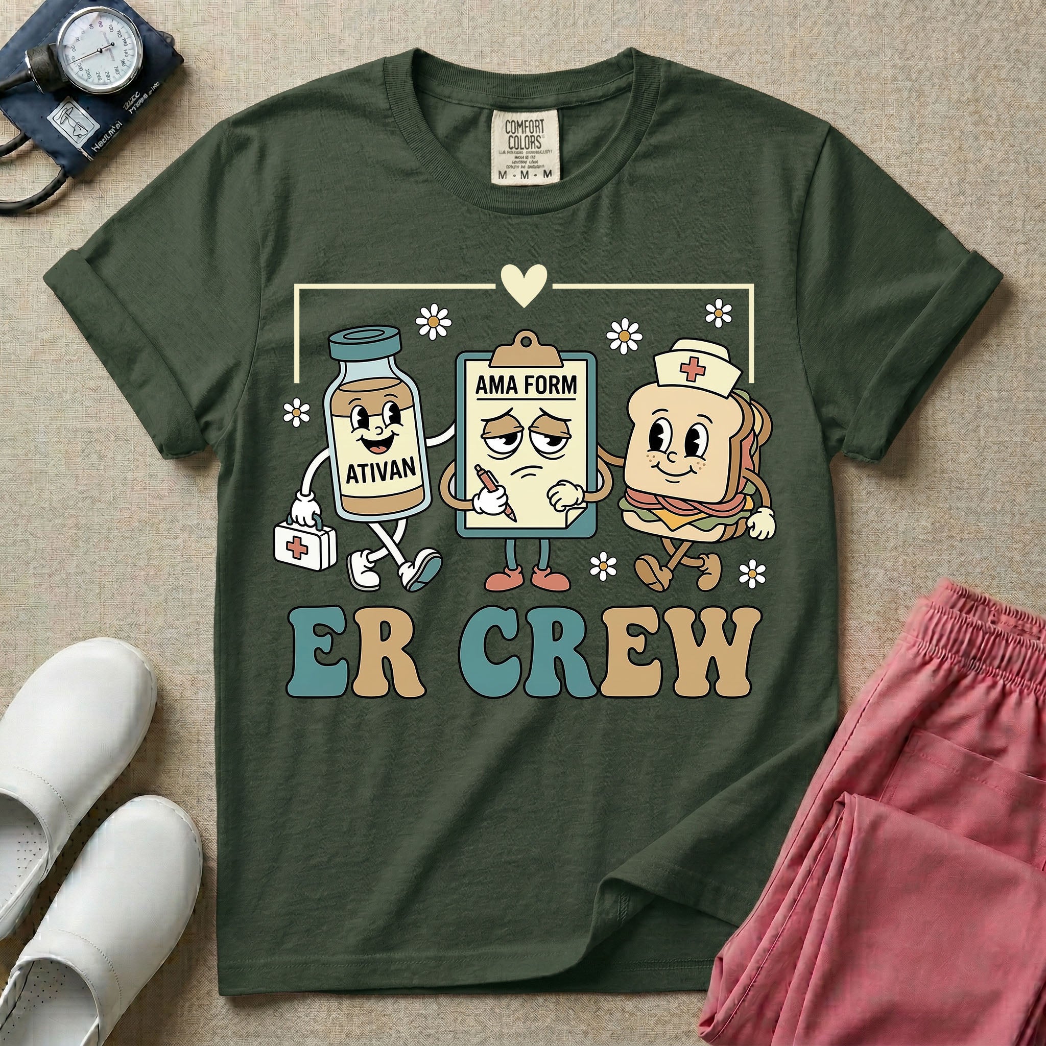 A retro-style t-shirt for emergency room nurses featuring the text "ER CREW" below a vintage cartoon illustration of a medicine bottle, a grumpy clipboard holding an AMA form, and a sandwich wearing a nurse cap walking together.