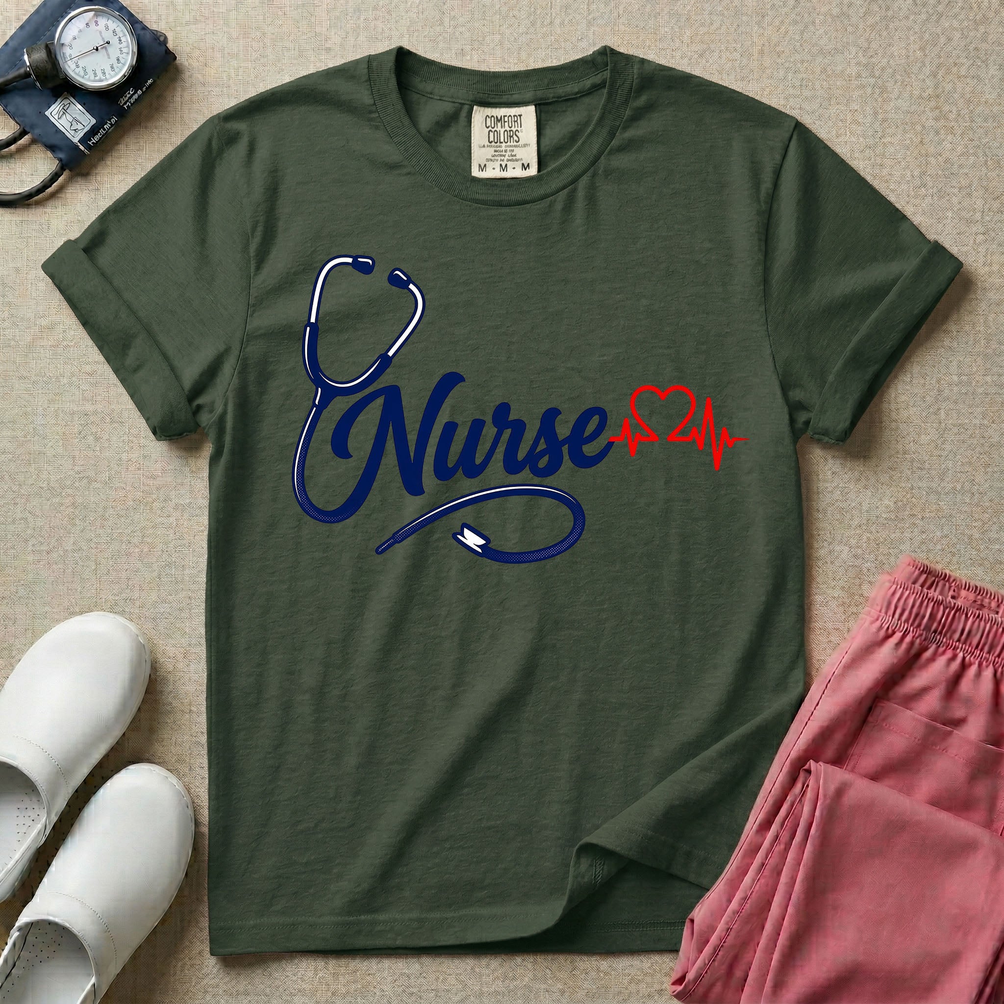 General nursing t-shirt with a minimalist cursive Nurse text integrated with a navy blue stethoscope and a red heartbeat graphic.