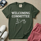 Labor and Delivery nurse graphic featuring a simple white outline of a flying stork carrying a baby bundle with a heart, placed below the text WELCOMING COMMITTEE.