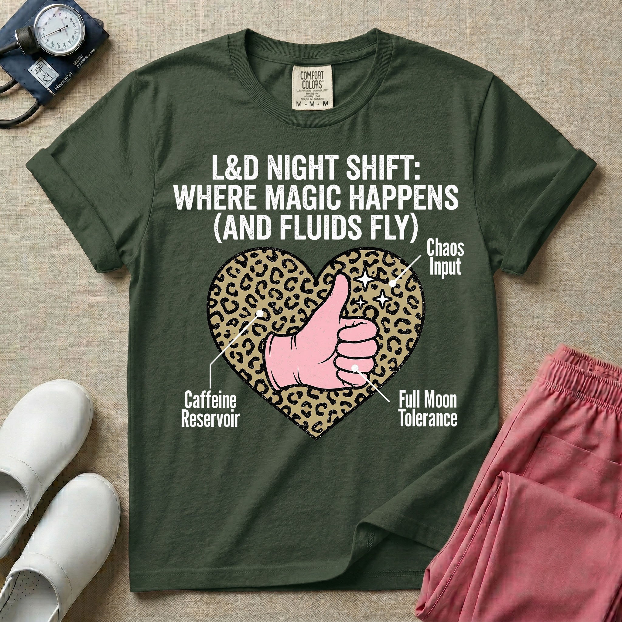 Labor and Delivery L&D nursing t-shirt featuring a leopard print heart diagram with a gloved thumbs-up and the text "L&D NIGHT SHIFT: WHERE MAGIC HAPPENS (AND FLUIDS FLY)"