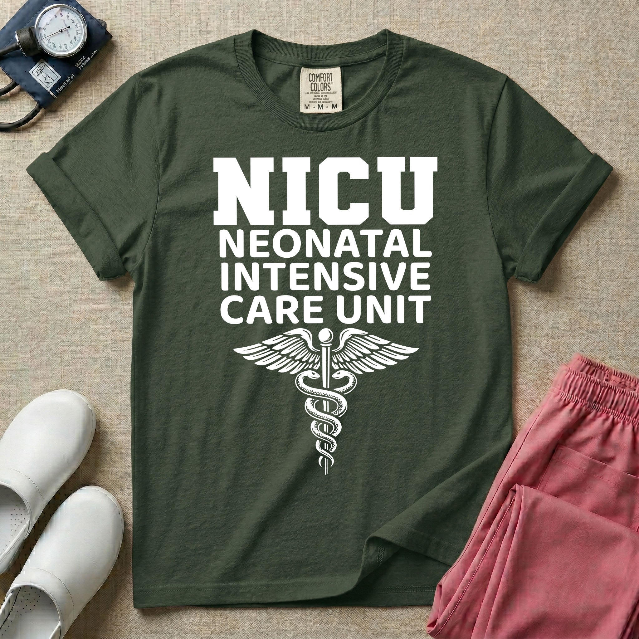 A t-shirt featuring the word NICU in large collegiate block letters above the spelled-out text Neonatal Intensive Care Unit and a medical caduceus symbol.