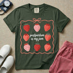A funny and cute postpartum nursing t-shirt featuring the pun text "postpartum is my jam" surrounded by a graphic of red and pink strawberries, enclosed in a decorative wavy border with a bow at the top.