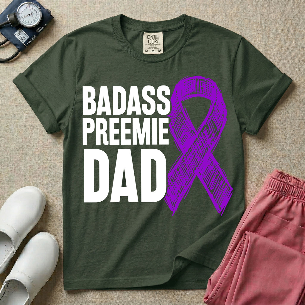 A graphic for the Neonatal Intensive Care Unit featuring the stacked, bold white text 'BADASS PREEMIE DAD' next to a large, textured purple awareness ribbon.