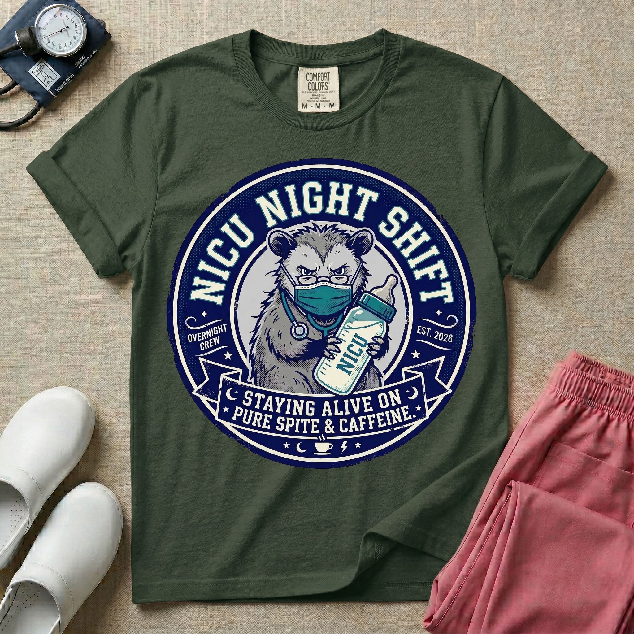 A humorous graphic for a Neonatal Intensive Care Unit featuring a circular design with an illustration of a tired raccoon wearing a medical face mask and holding a baby bottle labeled 'NICU', surrounded by the text 'NICU NIGHT SHIFT' at the top and 'STAYING ALIVE ON PURE SPITE & CAFFEINE' at the bottom.