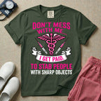 General nursing and ER t-shirt featuring a pink and black caduceus medical symbol flanked by two syringes alongside the humorous text "DON'T MESS WITH ME... I GET PAID TO STAB PEOPLE WITH SHARP OBJECTS".