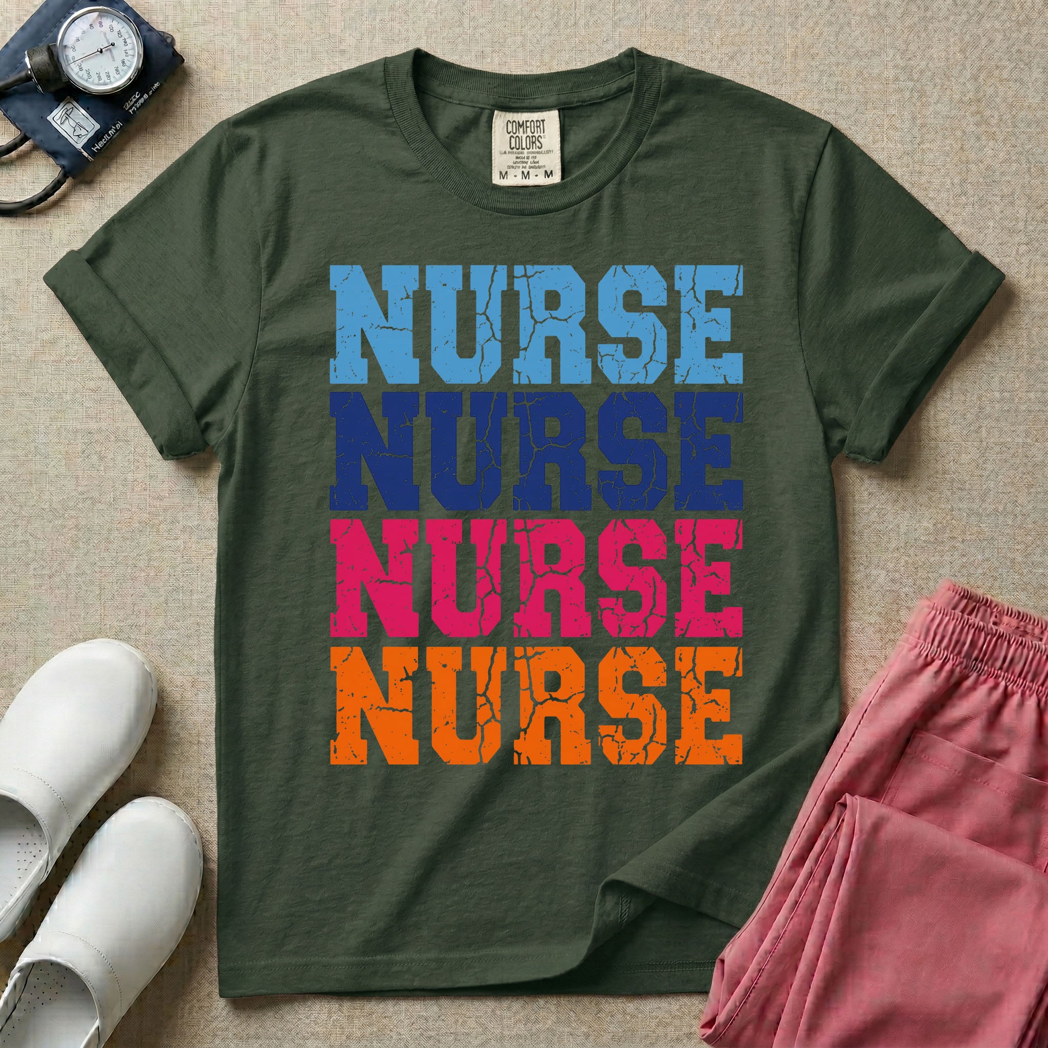 A t-shirt featuring the word NURSE repeated four times in a stacked vertical layout with a distressed, vintage texture in blue, navy, pink, and orange colors.