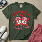 A t-shirt featuring two jars of strawberry jam surrounded by small hearts and strawberries with the text THE NICU IS MY JAM arched above and Neonatal ICU Nurse written in a retro script below.