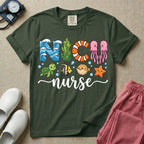 A cute t-shirt for NICU nurses featuring the text "NICU nurse" where the letters are designed with ocean elements like waves, seaweed, and a jellyfish, surrounded by under the sea creatures including a sea turtle, tropical fish, pufferfish, and starfish.
