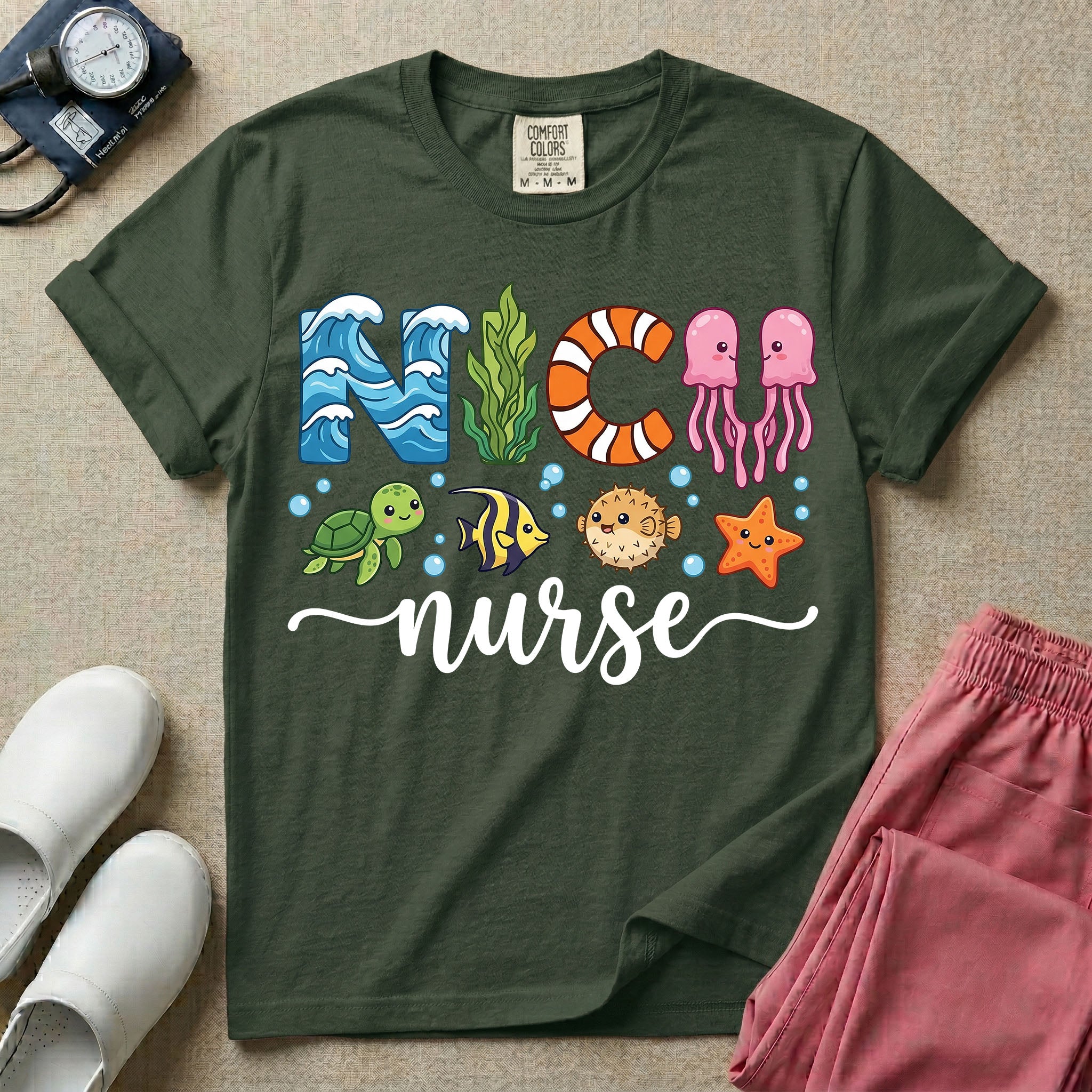 A cute t-shirt for NICU nurses featuring the text "NICU nurse" where the letters are designed with ocean elements like waves, seaweed, and a jellyfish, surrounded by under the sea creatures including a sea turtle, tropical fish, pufferfish, and starfish.