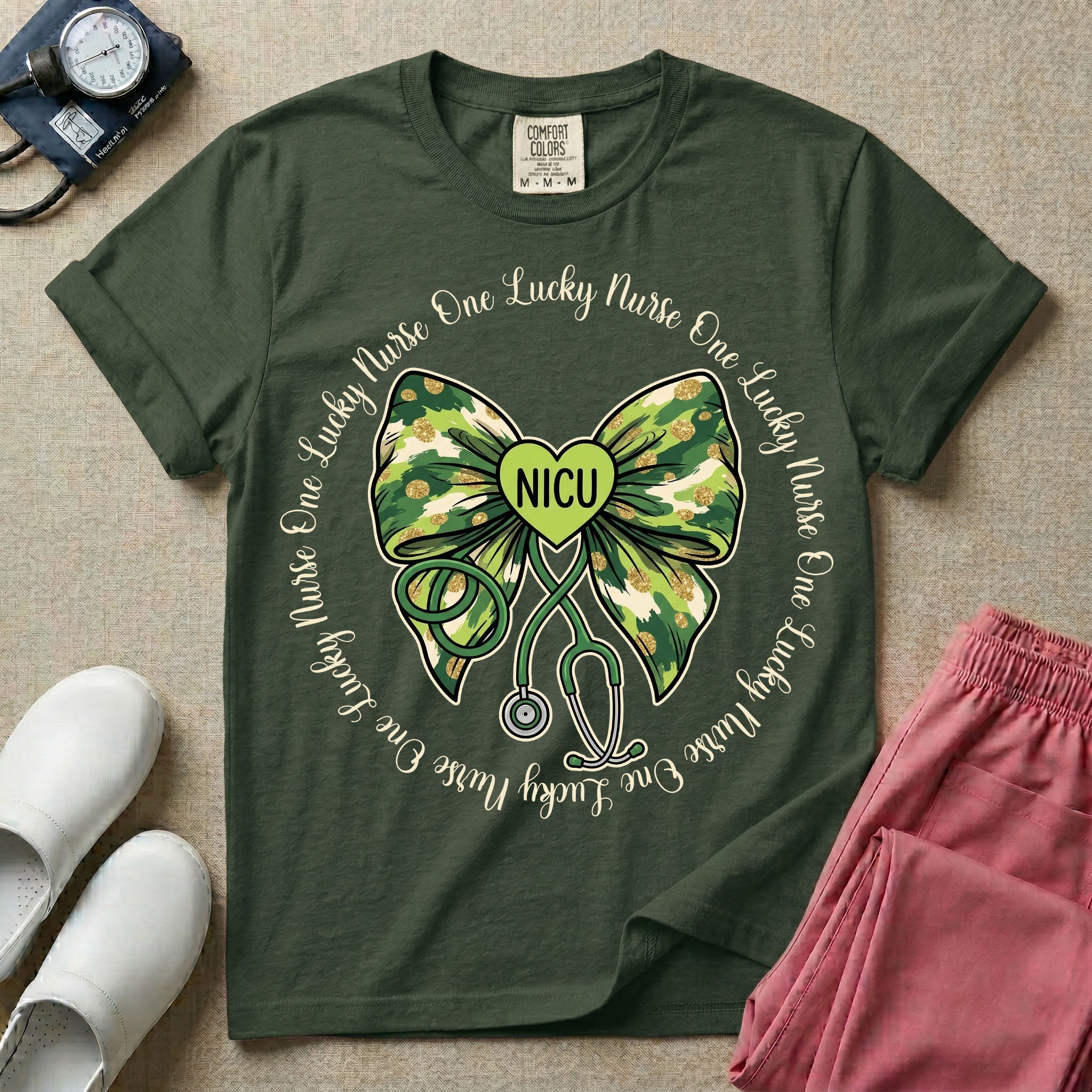 A graphic for a Neonatal Intensive Care Unit featuring a green camouflage bow with a stethoscope dangling from the bottom, a green heart in the center reading 'NICU', and the phrase 'One Lucky Nurse' repeating in a circle around the design.