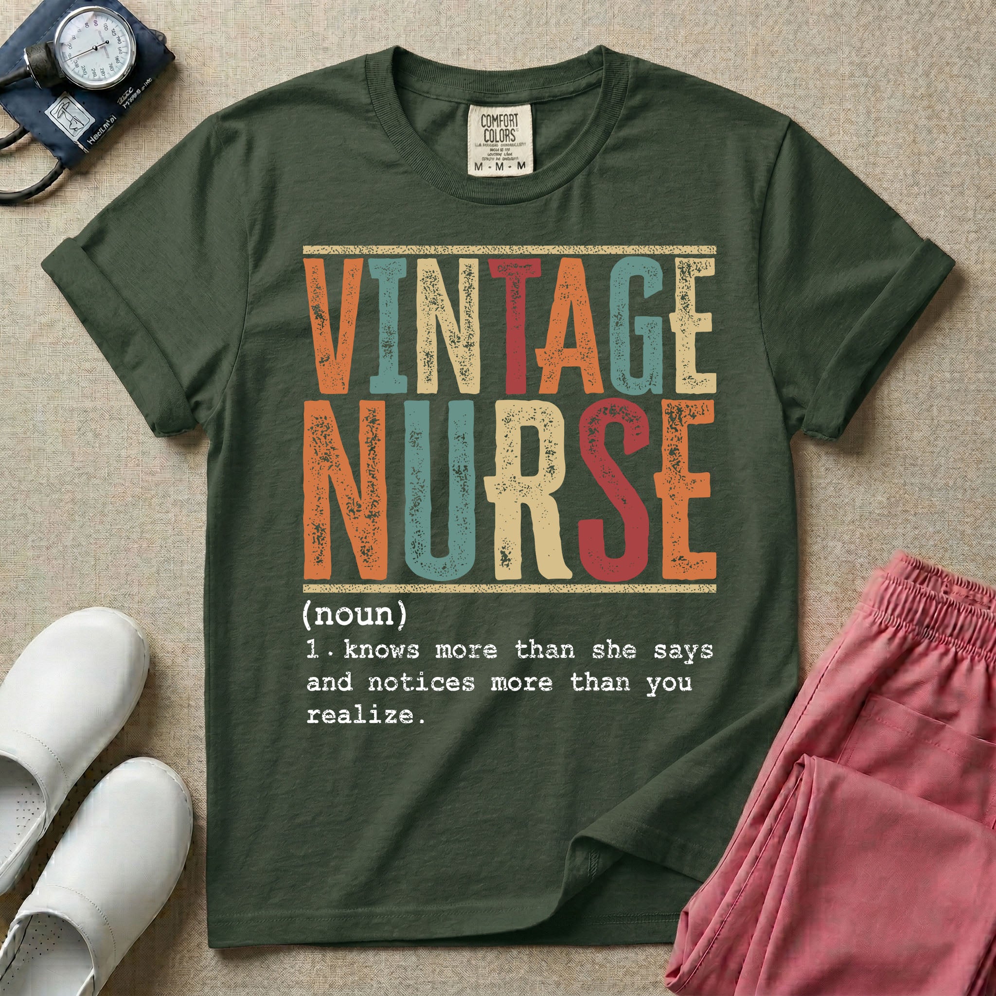 A humorous General Nursing graphic featuring large distressed retro-style block letters spelling VINTAGE NURSE, positioned above a dictionary-style definition in white typewriter font that reads (noun) 1. knows more than she says and notices more than you realize.