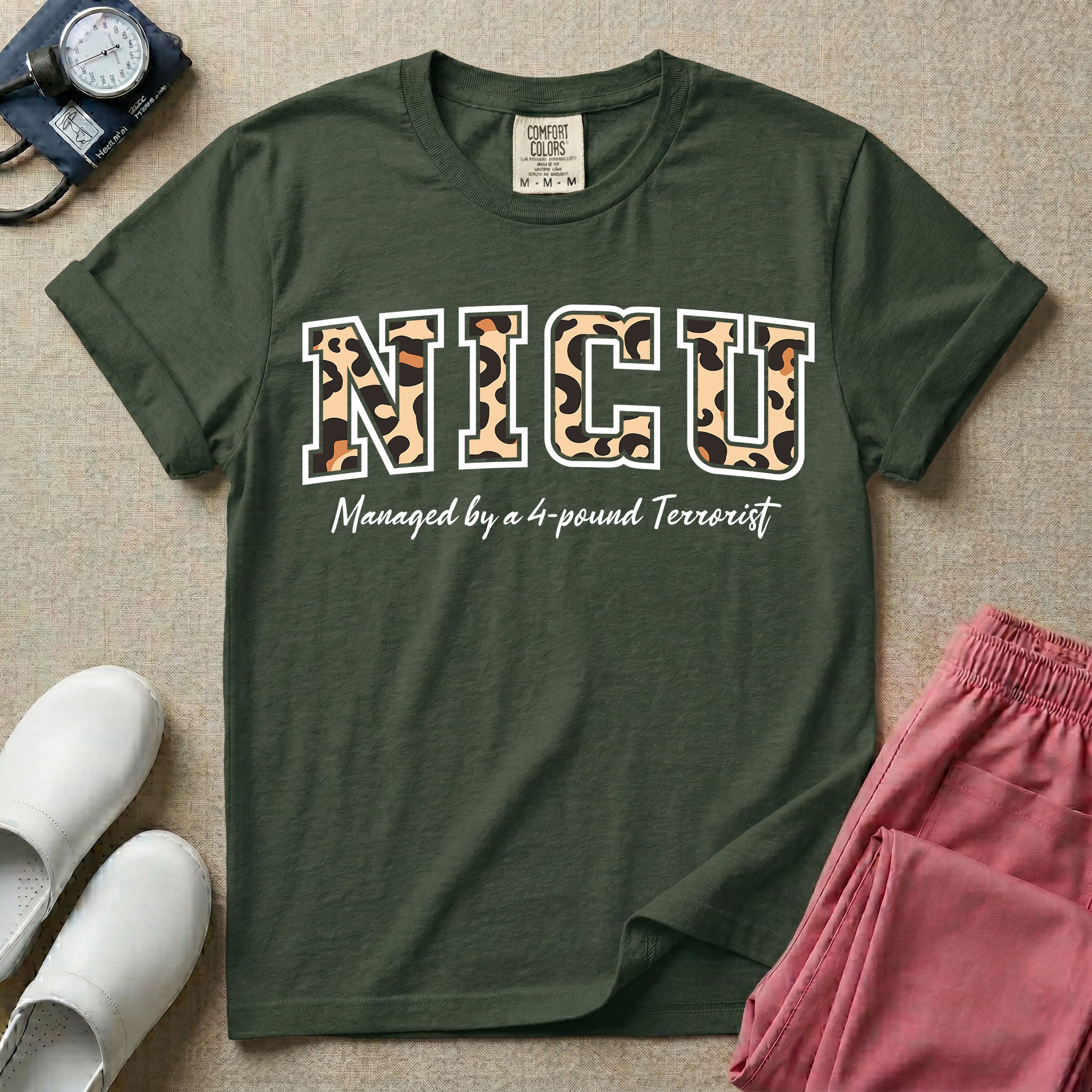Neonatal Intensive Care Unit NICU nurse t-shirt with leopard print block letters and funny managed by a 4-pound terrorist graphic in moss color.