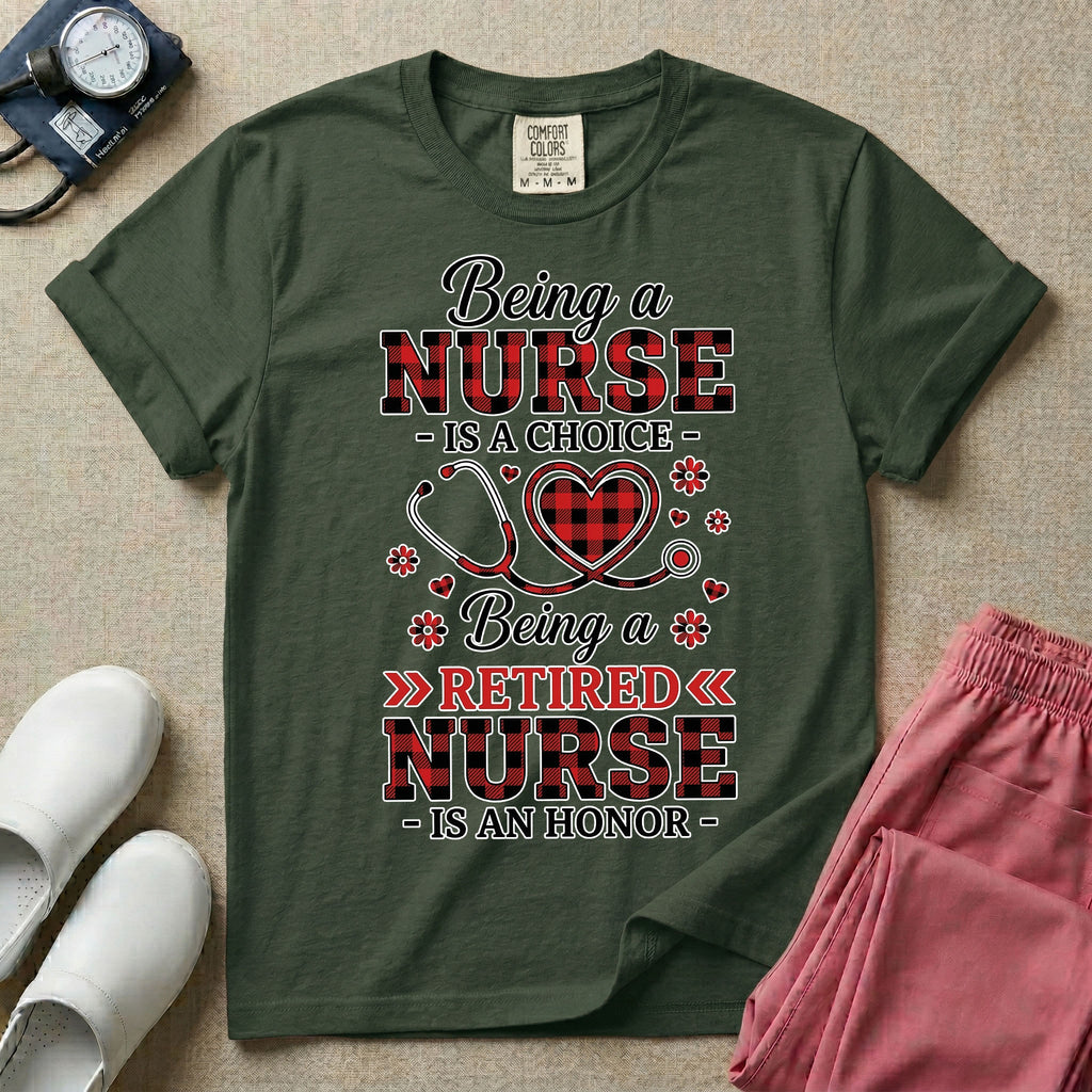 A t-shirt featuring the text Being a NURSE IS A CHOICE Being a RETIRED NURSE IS AN HONOR surrounding a central graphic of a red and black buffalo plaid heart intertwined with a stethoscope.