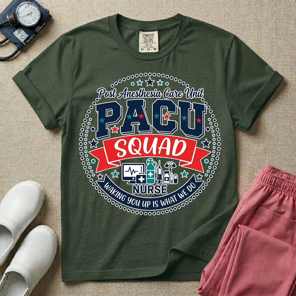 A t-shirt featuring a circular badge design with the text PACU SQUAD in block letters, medical icons like a heart monitor and stethoscope, and the phrase Waking You Up Is What We Do.