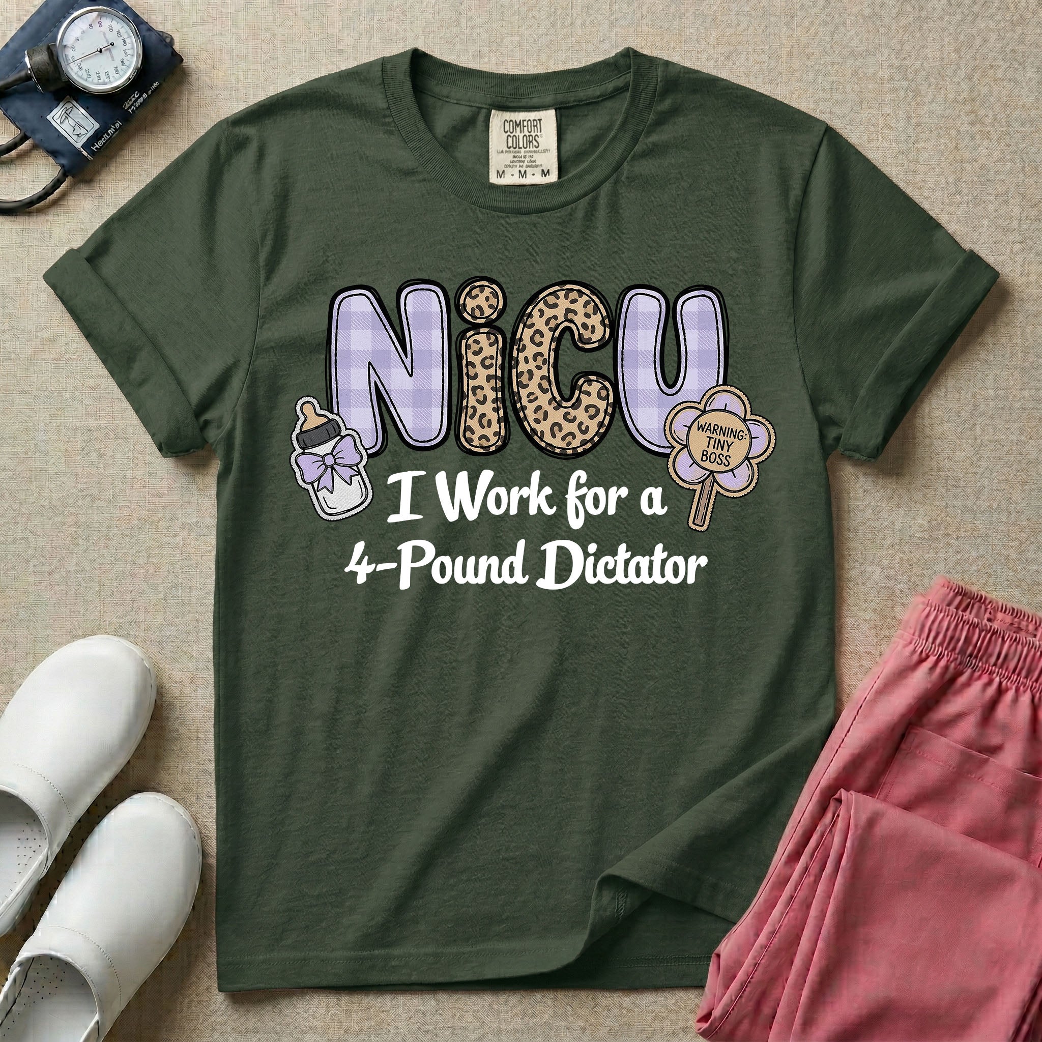 A funny t-shirt for NICU nurses featuring the text "NICU I Work for a 4-Pound Dictator" designed with purple plaid and leopard print letters, accompanied by graphics of a baby bottle with a bow and a rattle that says "WARNING: TINY BOSS".