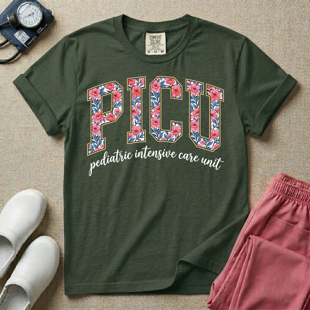 A boho pediatric intensive care nursing t-shirt featuring the large block text "PICU" filled with a decorative floral pattern, positioned above the cursive white text "pediatric intensive care unit".