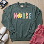 Retro Neonatal Nurse Smiley Face NICU Sweatshirt - Blue Spruce Comfort Colors Sweatshirt | HugTee