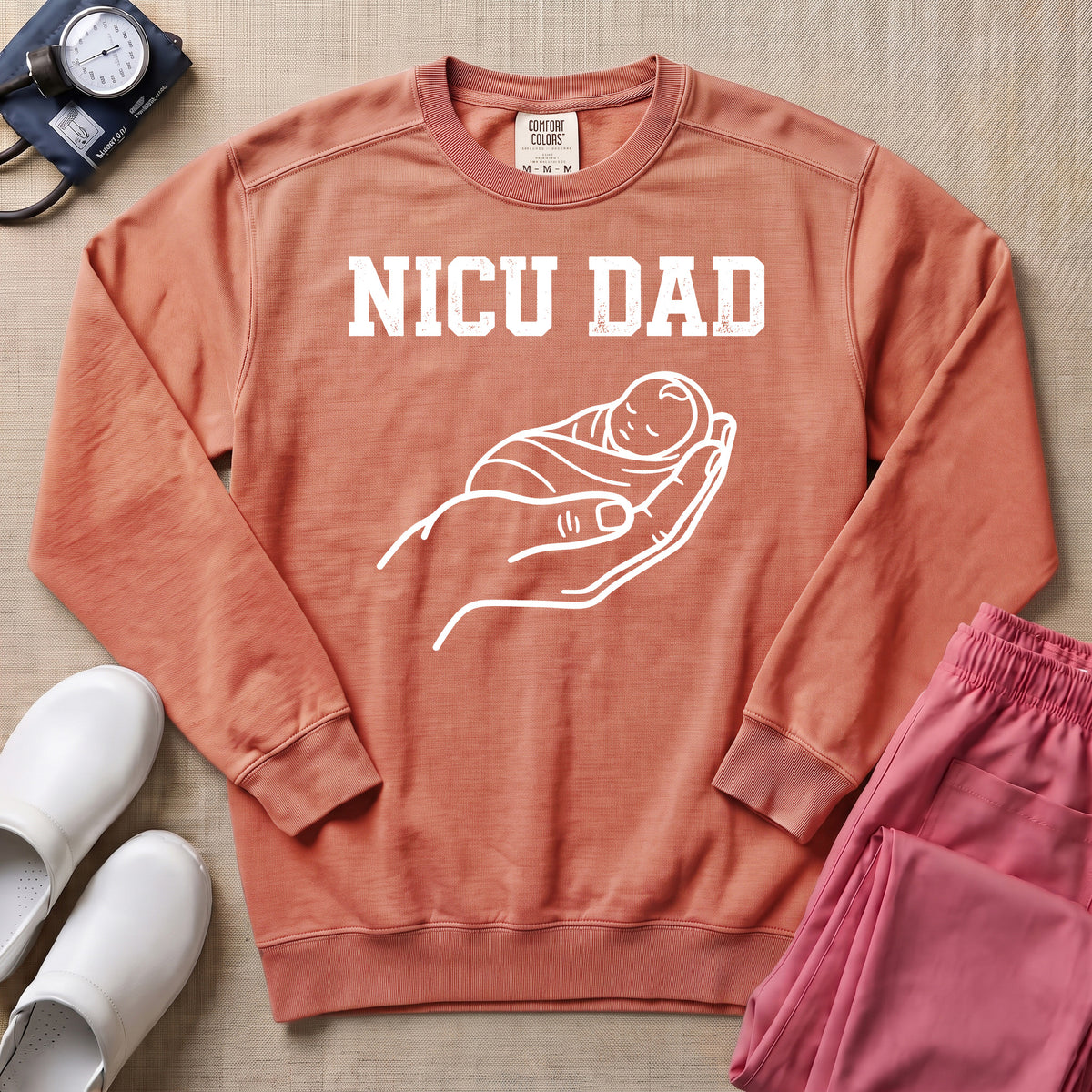 Proud NICU Dad Cradling Baby Line Art Minimalist Sweatshirt - Terracotta Comfort Colors Sweatshirt | HugTee