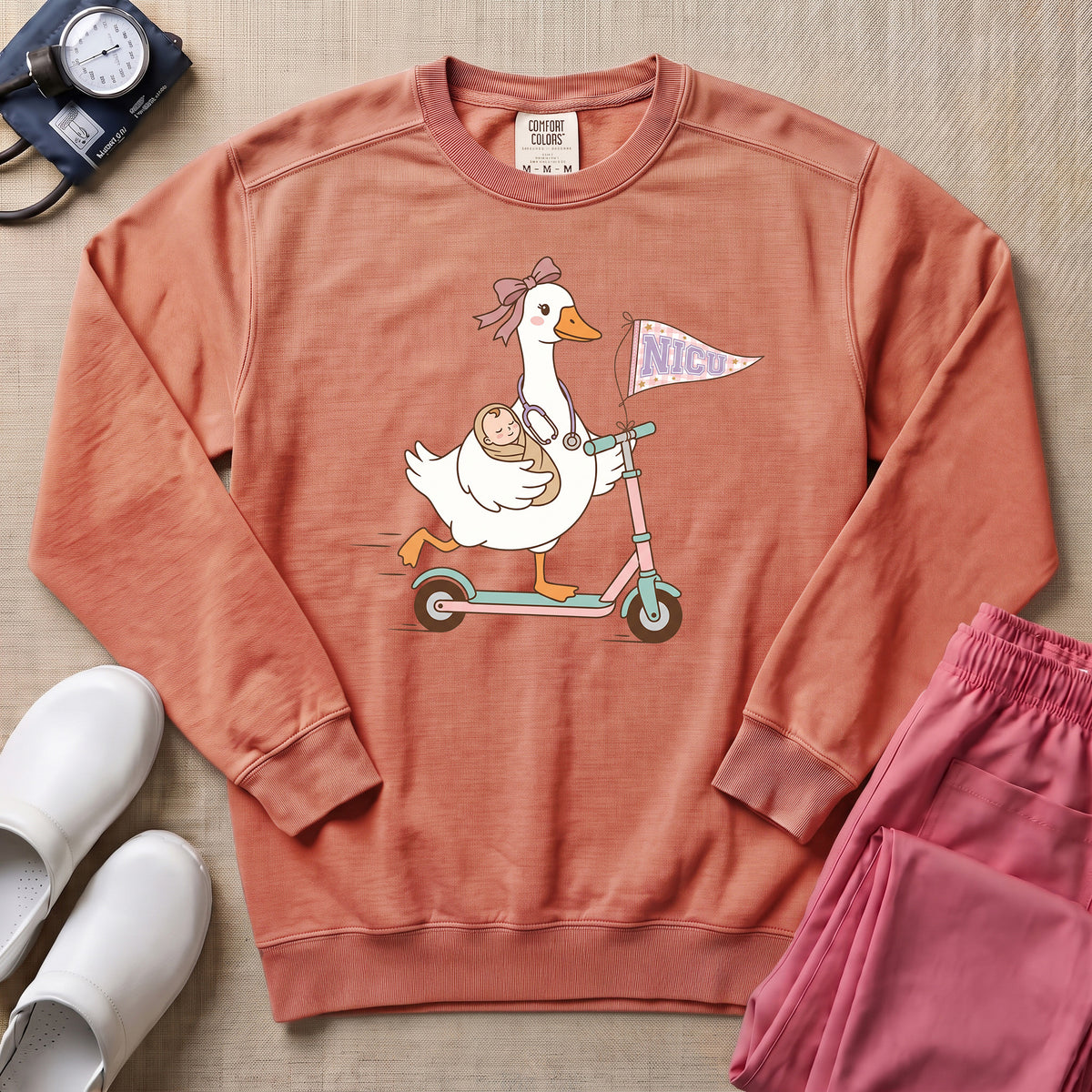 Coquette Goose Riding Scooter NICU Nurse Sweatshirt - Terracotta Comfort Colors Sweatshirt | HugTee