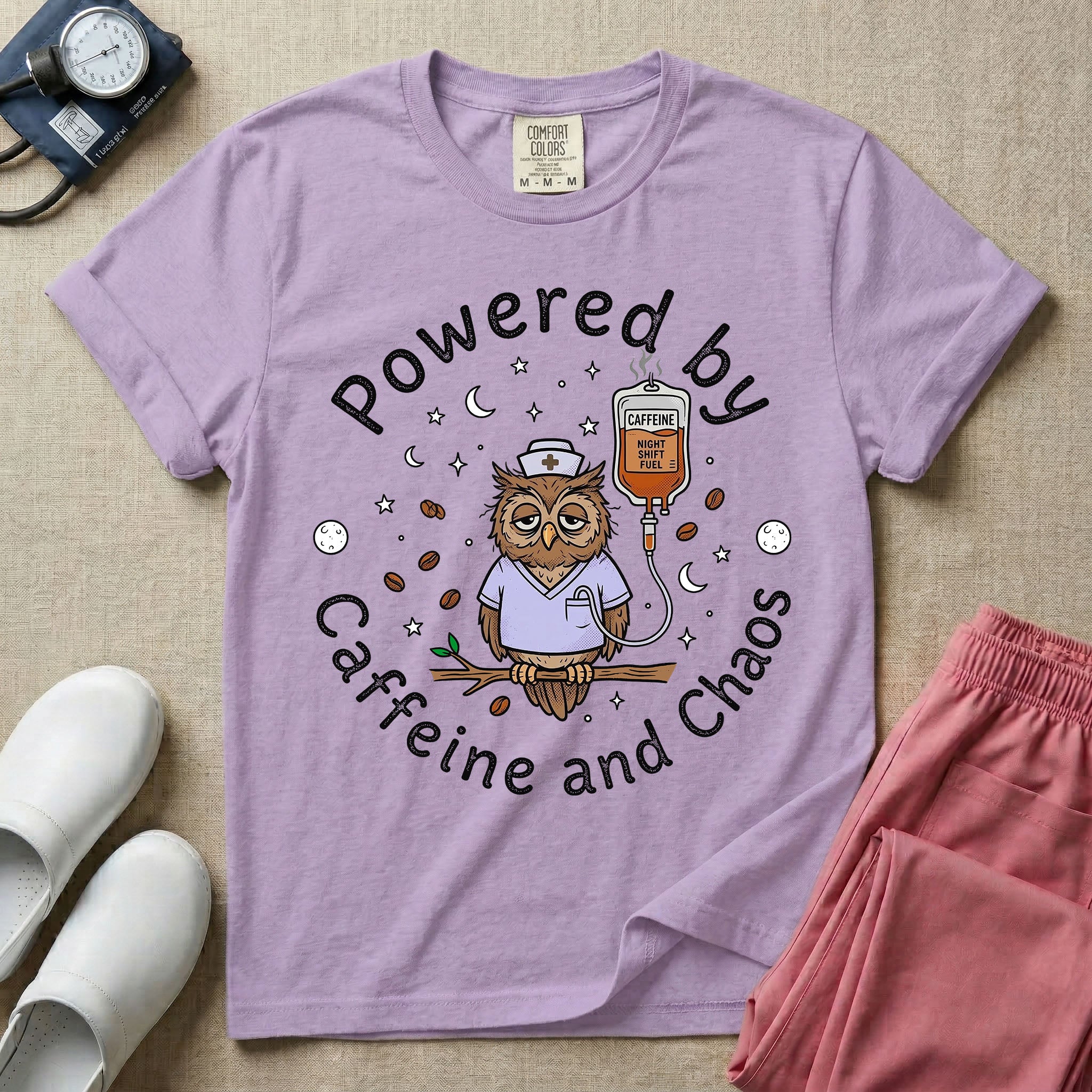 A humorous General Nursing graphic featuring an exhausted owl wearing scrubs and a nurse hat, hooked up to an IV bag labeled CAFFEINE NIGHT SHIFT FUEL, surrounded by coffee beans, stars, and moons, with circular text reading Powered by Caffeine and Chaos.