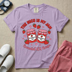 A t-shirt featuring two jars of strawberry jam surrounded by small hearts and strawberries with the text THE NICU IS MY JAM arched above and Neonatal ICU Nurse written in a retro script below.