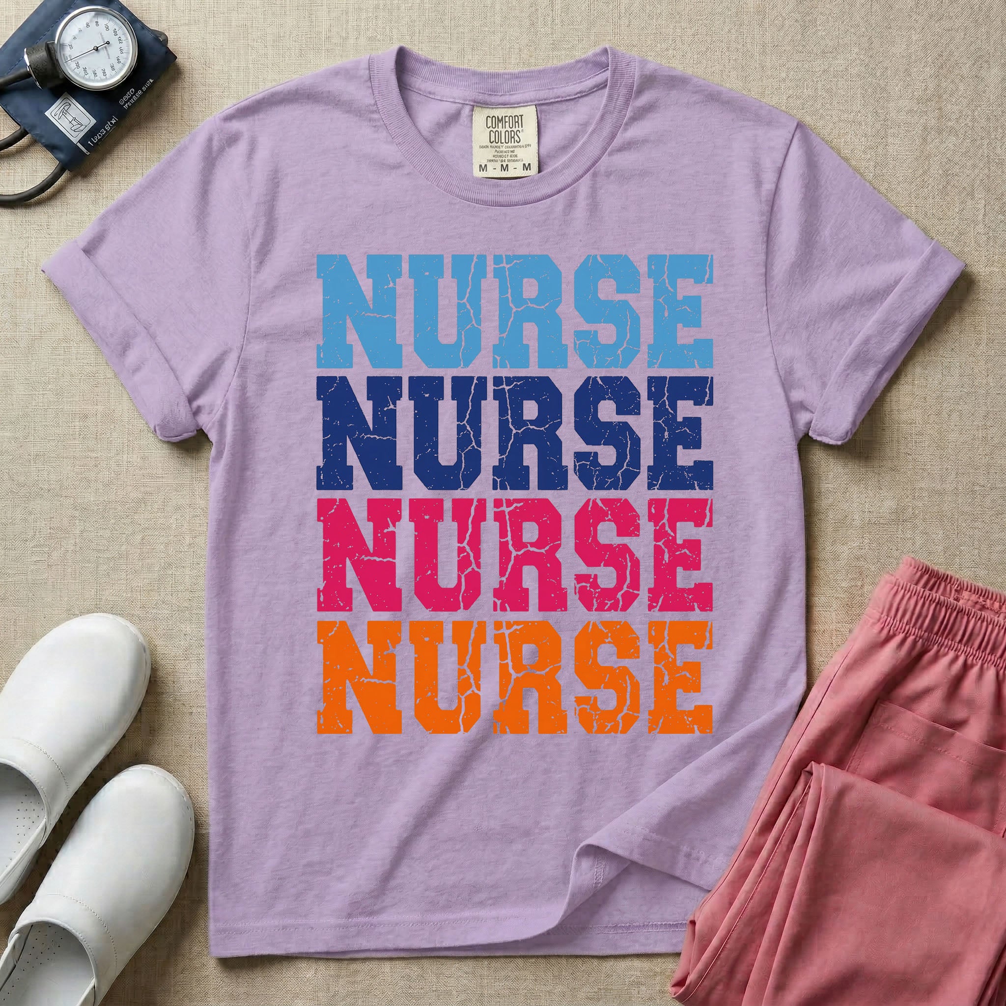 A t-shirt featuring the word NURSE repeated four times in a stacked vertical layout with a distressed, vintage texture in blue, navy, pink, and orange colors.