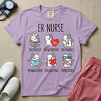 A funny t-shirt for emergency room nurses featuring the text "ER NURSE" above a grid of six cute cartoon cats demonstrating medical puns, including a cat reading for "PAWTHOLOGY", a cat with an ECG heart for "MEOWTABOLISM", a cat holding a test tube for "LAB PAWNELS", a cat with pills for "MEOWDICATION", a cat holding a heart for "HEALING PAWS", and a cat with a stethoscope for "PURRCEDURES".
