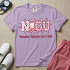 Retro coquette style t-shirt graphic featuring decorative pink 'NICU' text with checkerboard and heart patterns, incorporating a baby bottle with a bow and hearts, and the cursive text 'Neonatal Intensive Care Unit' below.
