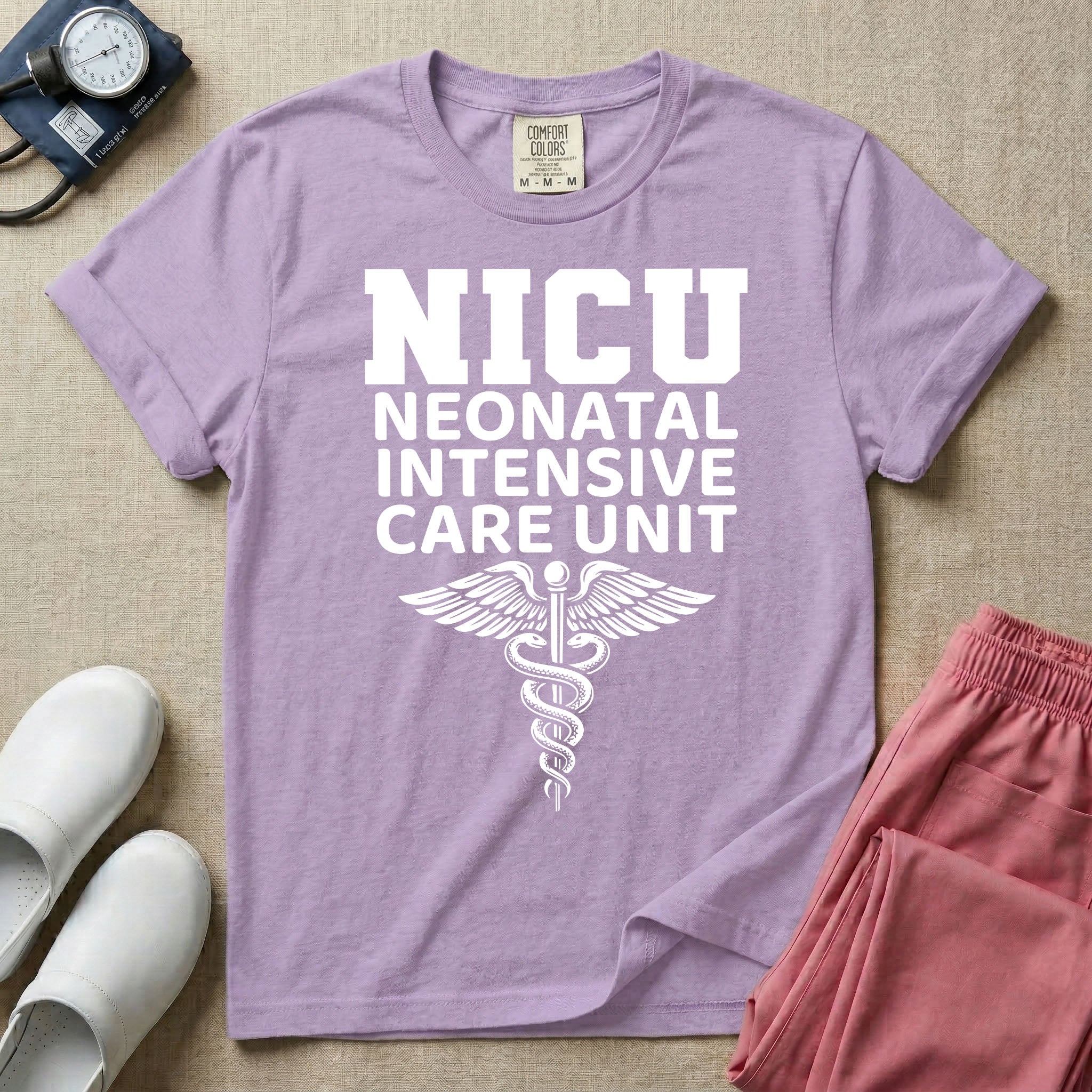 A t-shirt featuring the word NICU in large collegiate block letters above the spelled-out text Neonatal Intensive Care Unit and a medical caduceus symbol.