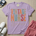 A humorous General Nursing graphic featuring large distressed retro-style block letters spelling VINTAGE NURSE, positioned above a dictionary-style definition in white typewriter font that reads (noun) 1. knows more than she says and notices more than you realize.