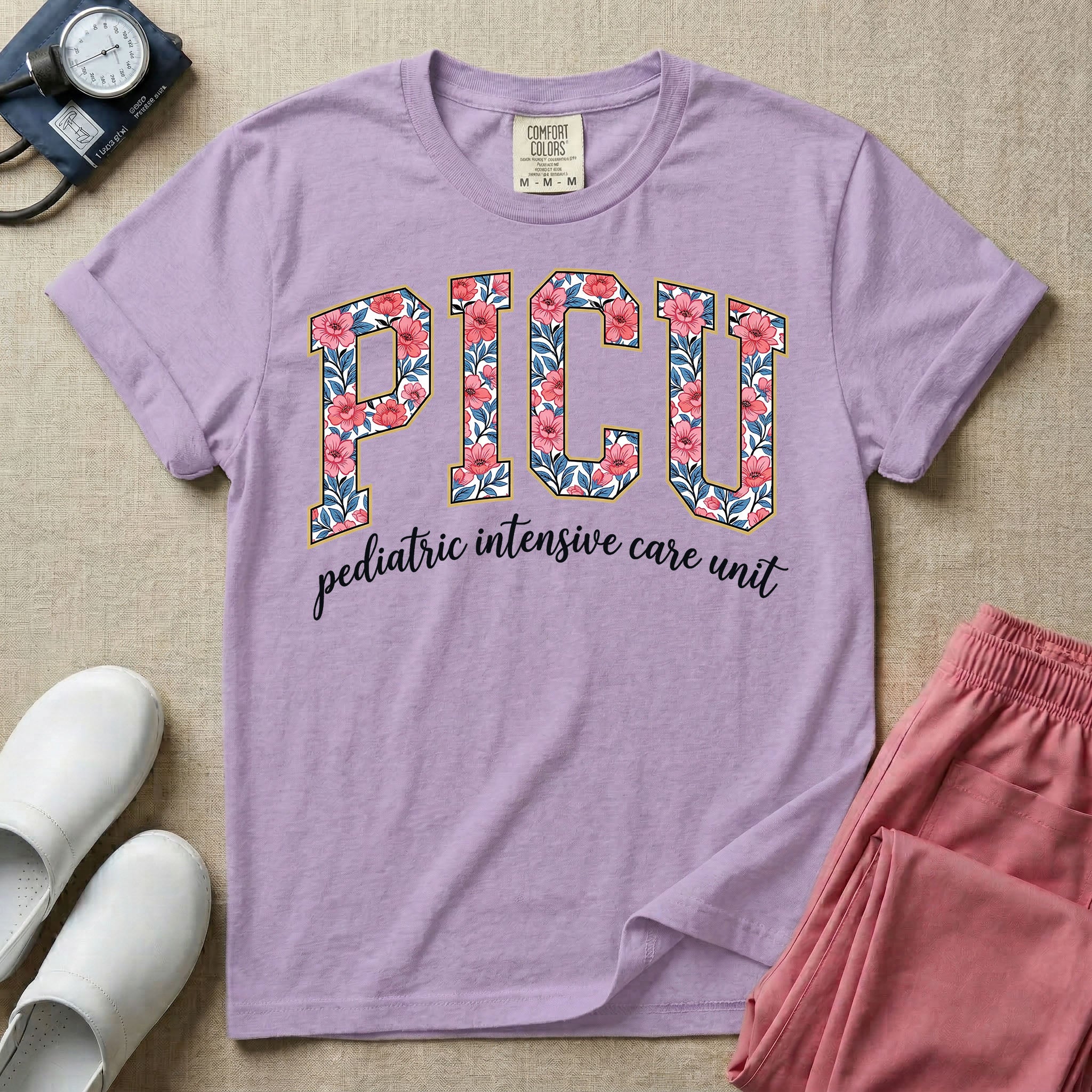 A boho pediatric intensive care nursing t-shirt featuring the large block text "PICU" filled with a decorative floral pattern, positioned above the cursive white text "pediatric intensive care unit".