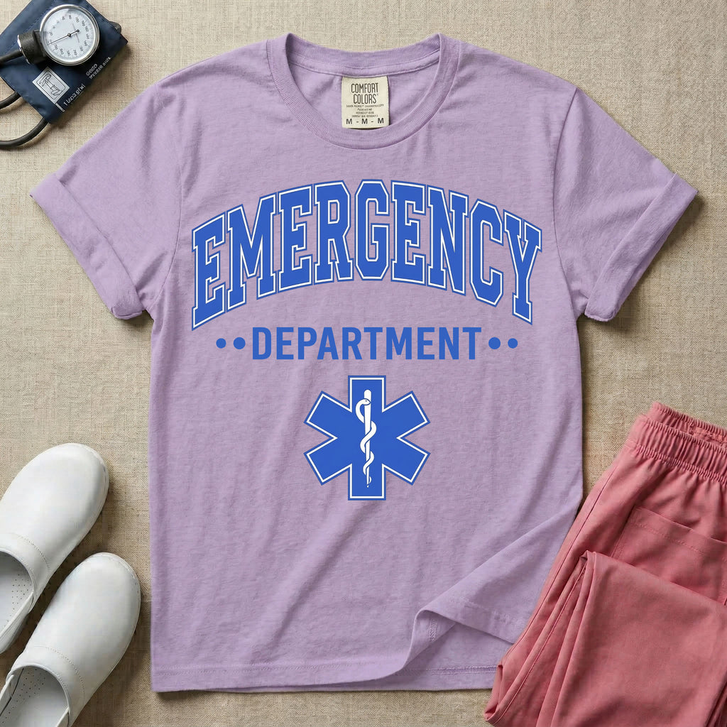 A classic varsity-style t-shirt for emergency room nurses featuring the word "EMERGENCY" in a large, arched blue collegiate font above the word "DEPARTMENT", centered over a blue Star of Life medical symbol.
