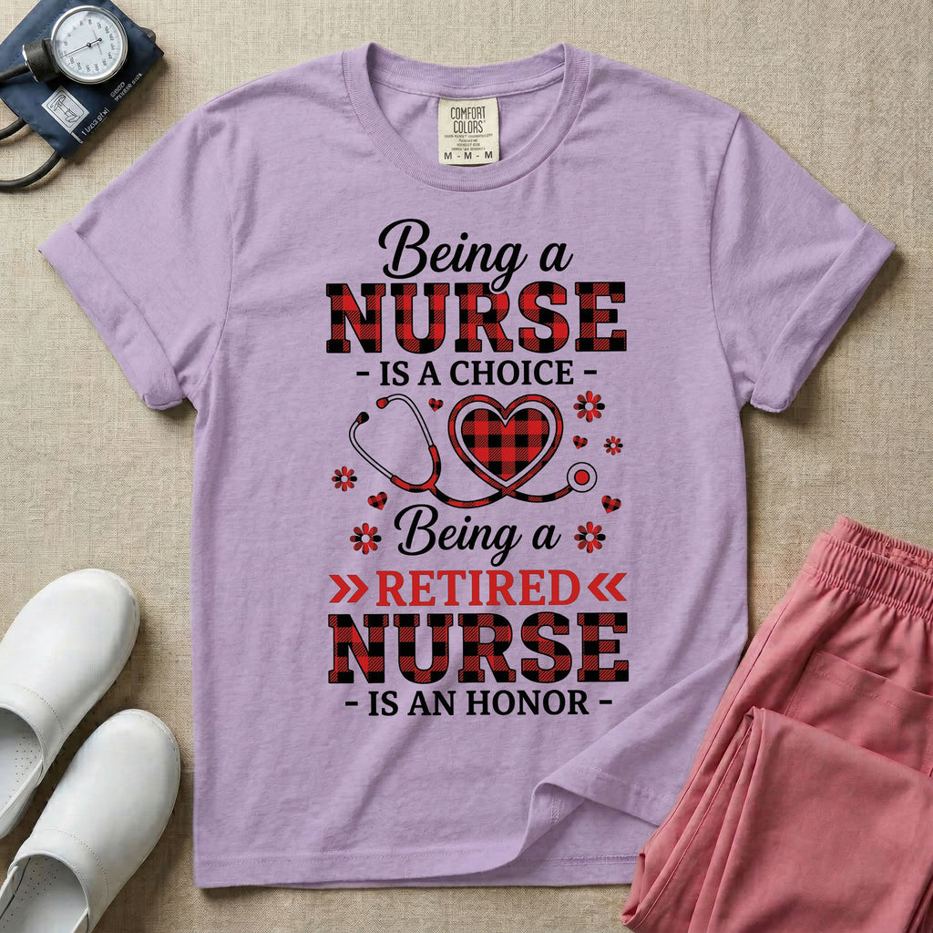 A t-shirt featuring the text Being a NURSE IS A CHOICE Being a RETIRED NURSE IS AN HONOR surrounding a central graphic of a red and black buffalo plaid heart intertwined with a stethoscope.