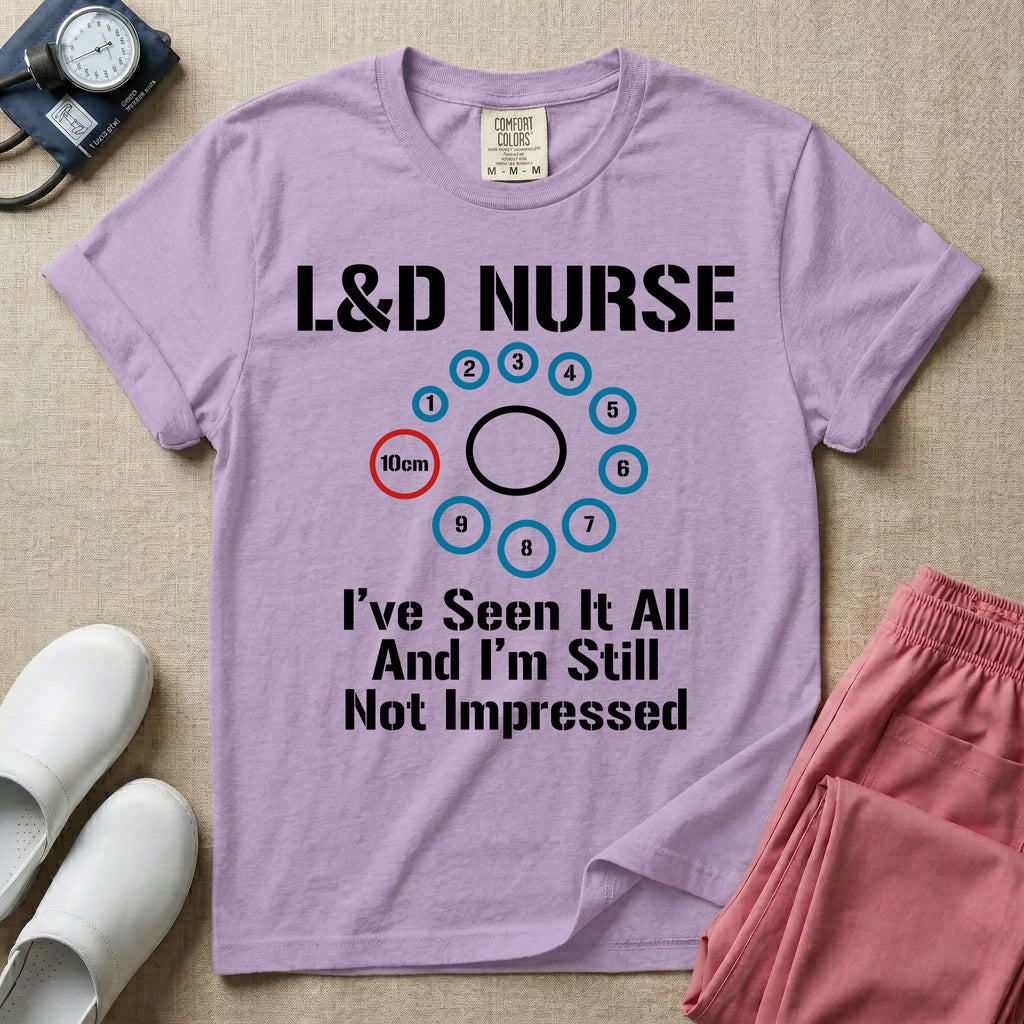 A humorous Labor and Delivery nurse t-shirt featuring a cervical dilation chart graphic highlighting 10cm, with the text "L&D NURSE" at the top and "I've Seen It All And I'm Still Not Impressed" at the bottom.