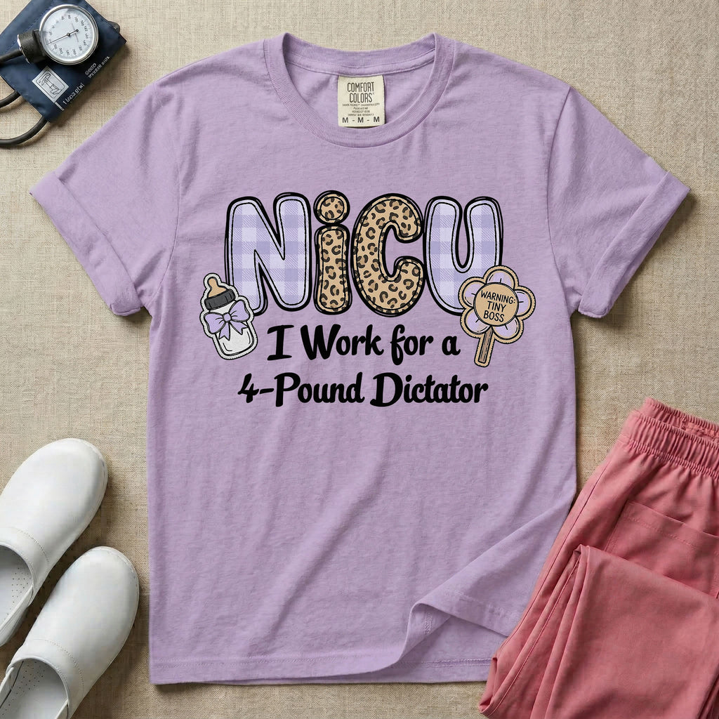 A funny t-shirt for NICU nurses featuring the text "NICU I Work for a 4-Pound Dictator" designed with purple plaid and leopard print letters, accompanied by graphics of a baby bottle with a bow and a rattle that says "WARNING: TINY BOSS".