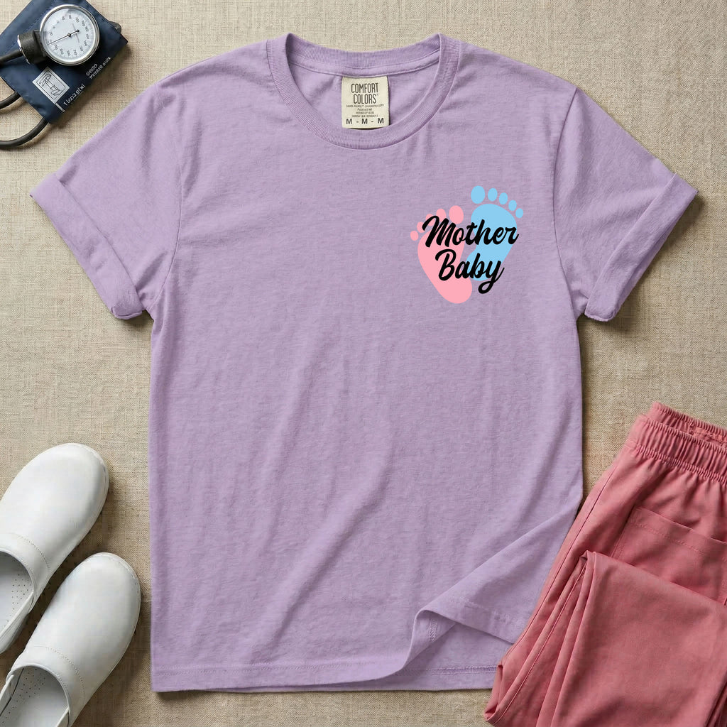 A minimalist postpartum nursing t-shirt featuring a small left chest graphic of two baby footprints, one pink and one blue, with the cursive white text "Mother Baby" written across them.