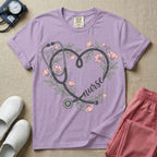 General nursing t-shirt featuring a heart-shaped stethoscope design intertwined with pink flowers and the cursive text "nurse".