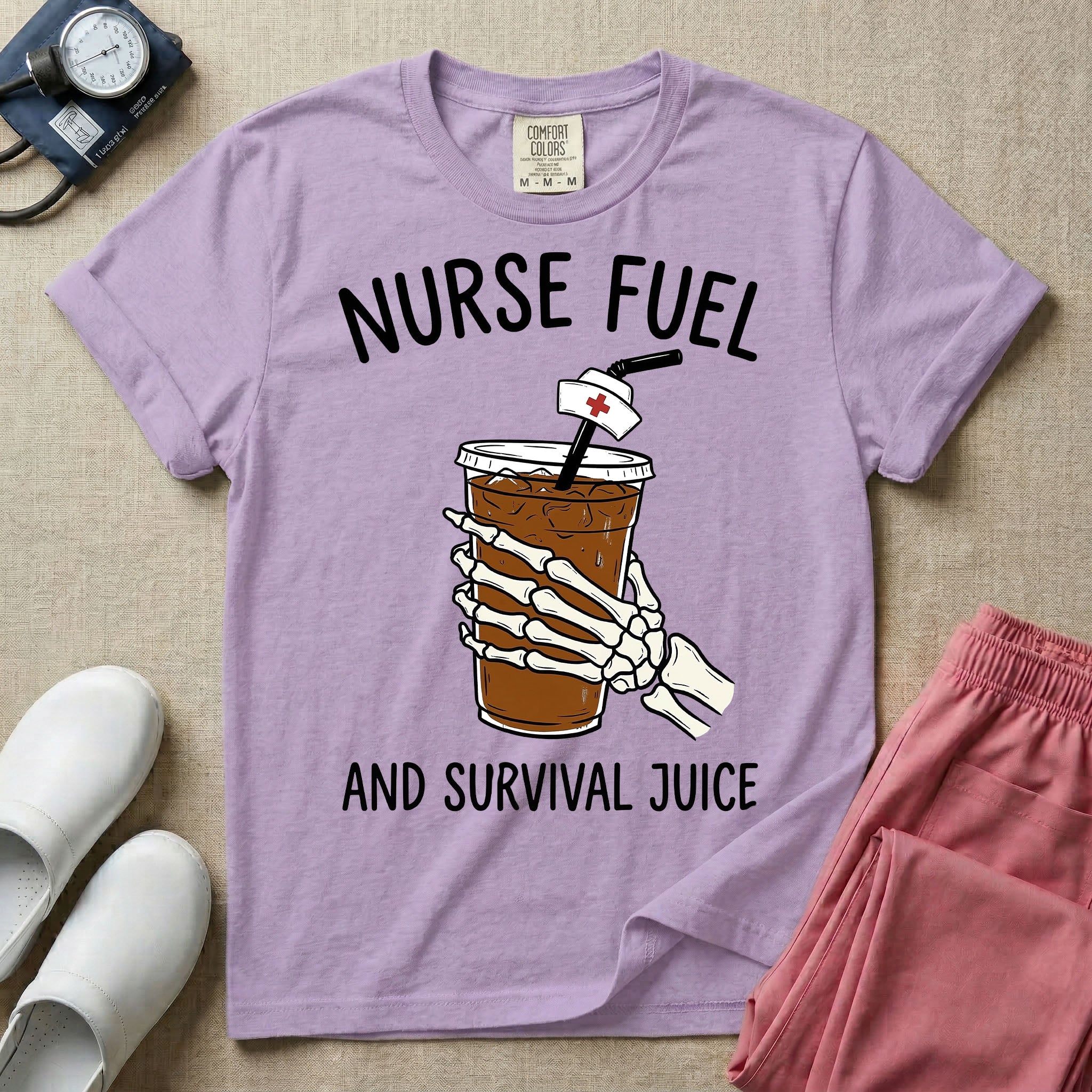 General nursing t-shirt featuring a graphic of a skeleton hand holding an iced coffee cup with a nurse cap on the straw and the text "NURSE FUEL AND SURVIVAL JUICE"
