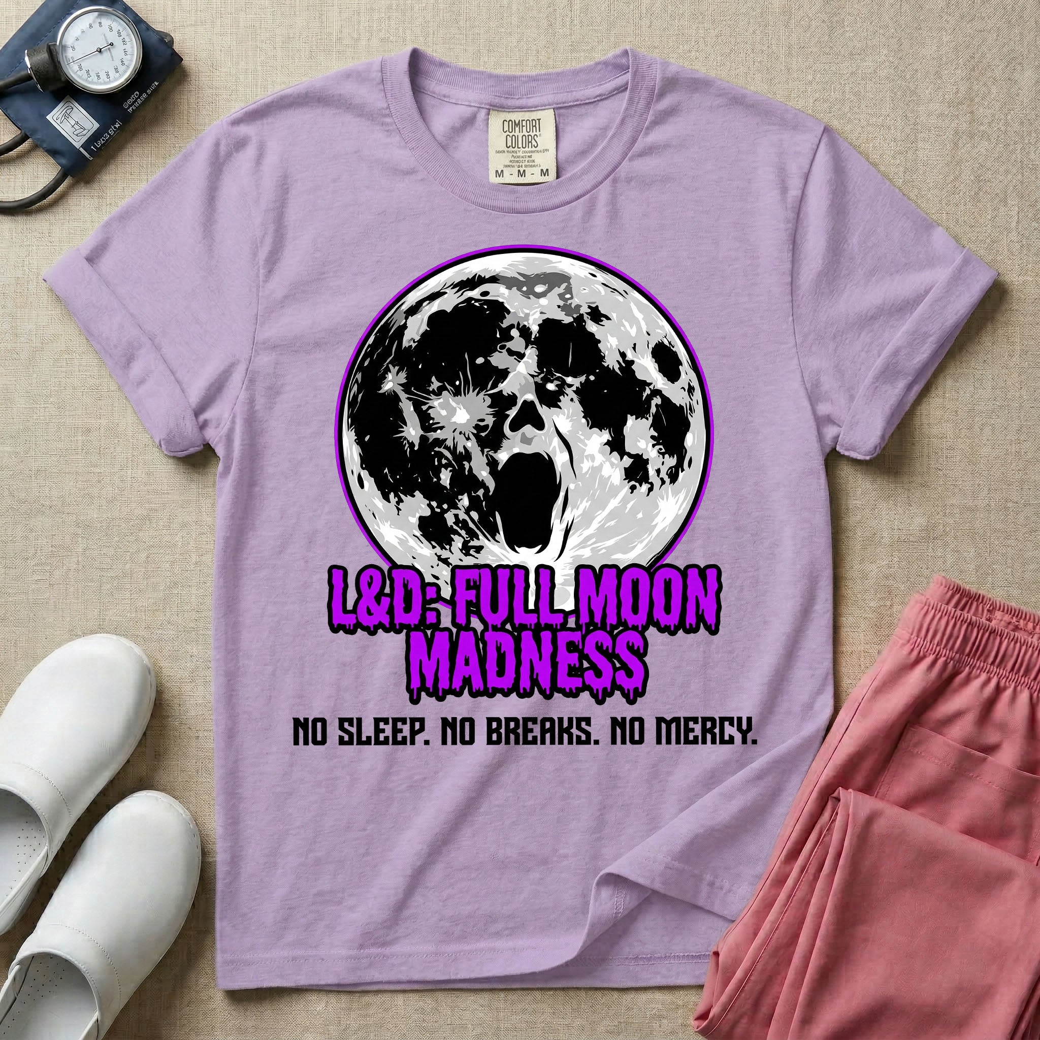 A humorous Labor and Delivery nurse graphic featuring a screaming face morphing out of a full moon, accompanied by purple dripping text that reads L&D: FULL MOON MADNESS and distressed black text below reading NO SLEEP. NO BREAKS. NO MERCY.