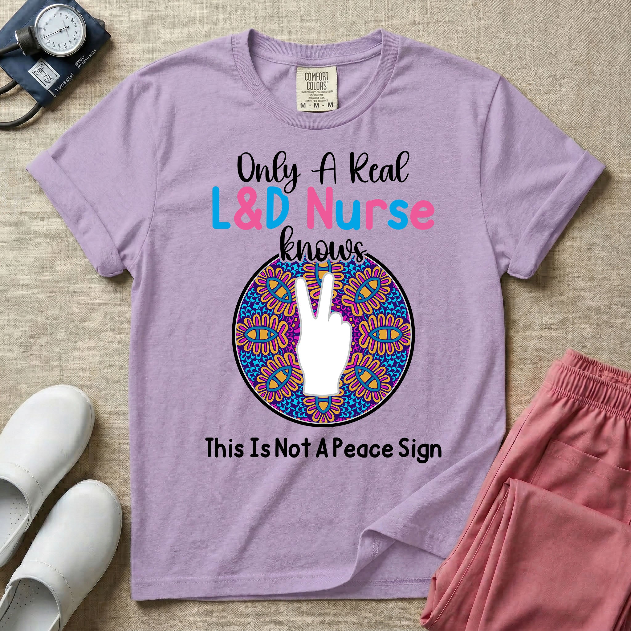 A humorous Labor and Delivery nurse graphic featuring a hand holding up two fingers inside a colorful boho mandala pattern, surrounded by text that reads Only A Real L&D Nurse Knows above and This Is Not A Peace Sign below.