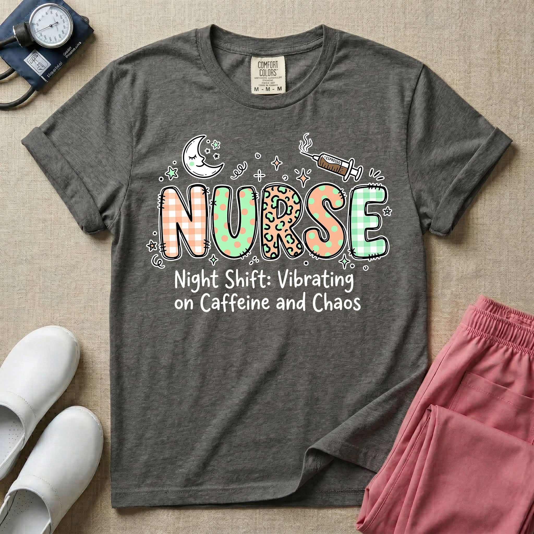 A humorous General Nursing graphic featuring the word NURSE in large, playfully patterned letters including plaid, leopard print, and floral designs, accented by a sleeping crescent moon and a syringe, positioned above text that reads Night Shift: Vibrating on Caffeine and Chaos.