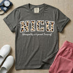 Neonatal Intensive Care Unit NICU nurse t-shirt with leopard print block letters and funny managed by a 4-pound terrorist graphic in pepper color.