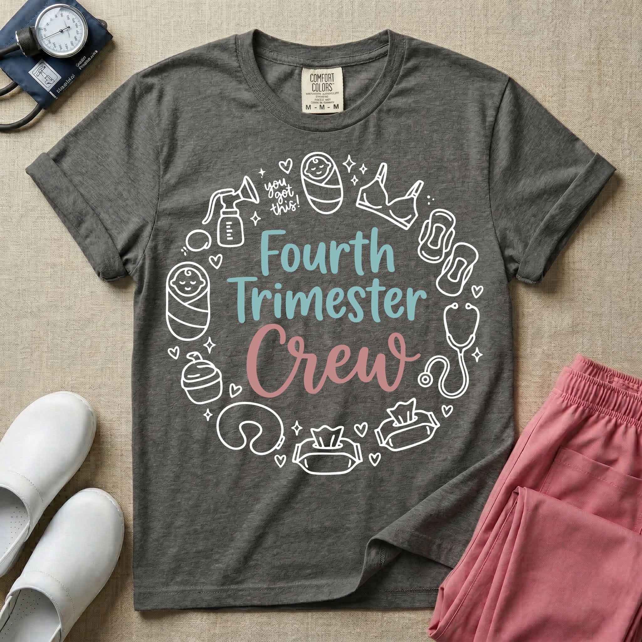 A postpartum nursing t-shirt featuring the stacked text "Fourth Trimester Crew" in blue and pink retro fonts, surrounded by a circular border of white minimalist line drawings depicting newborn and postpartum care items including a breast pump, swaddled baby, maternity bra, maxi pad, stethoscope, wipes, and a nursing pillow.