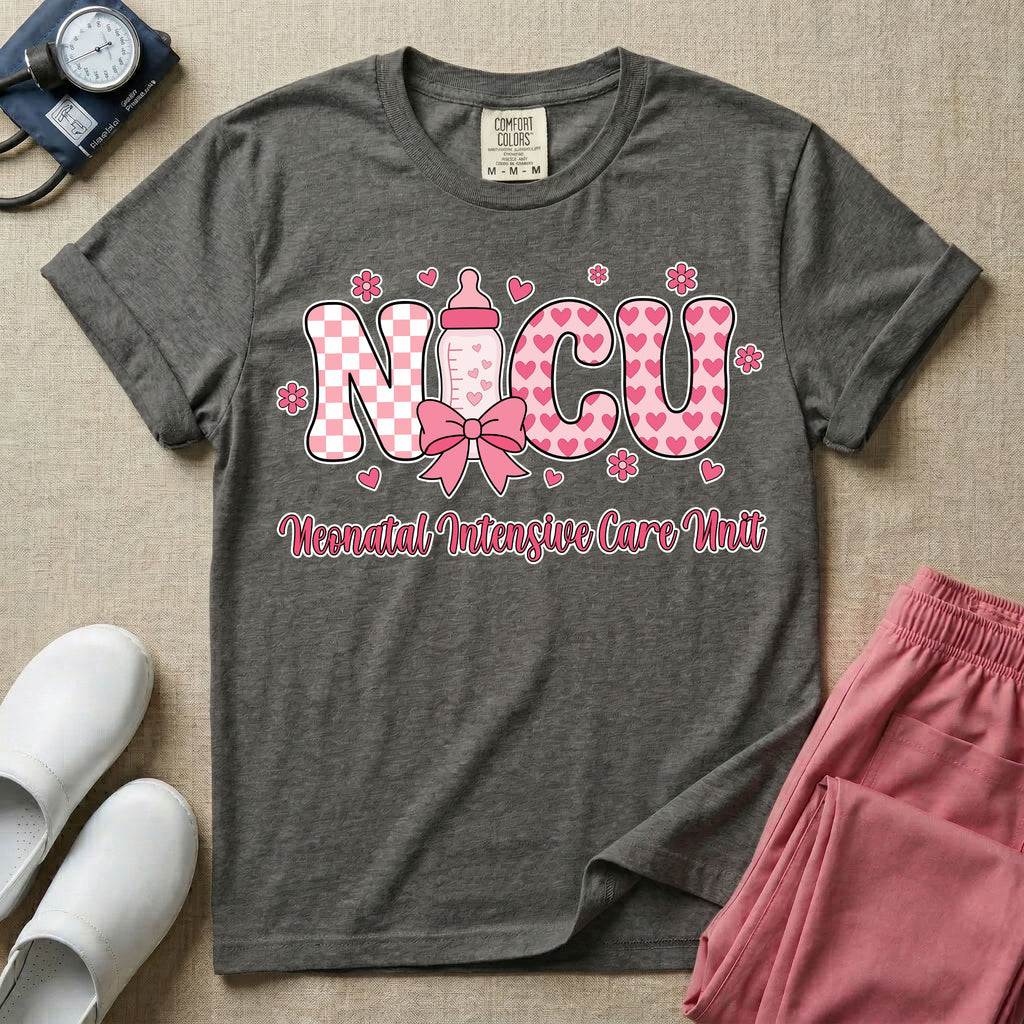Retro coquette style t-shirt graphic featuring decorative pink 'NICU' text with checkerboard and heart patterns, incorporating a baby bottle with a bow and hearts, and the cursive text 'Neonatal Intensive Care Unit' below.