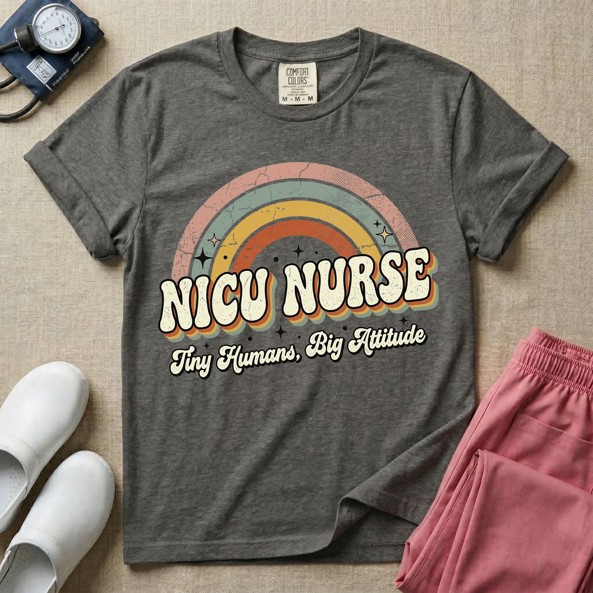 Neonatal Intensive Care Unit NICU nurse t-shirt with a retro vintage rainbow and tiny humans big attitude graphic in pepper color.