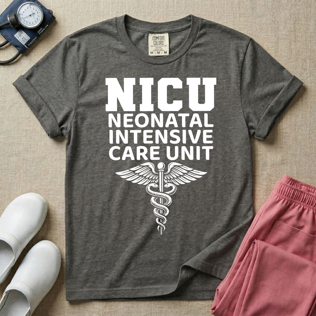 A t-shirt featuring the word NICU in large collegiate block letters above the spelled-out text Neonatal Intensive Care Unit and a medical caduceus symbol.