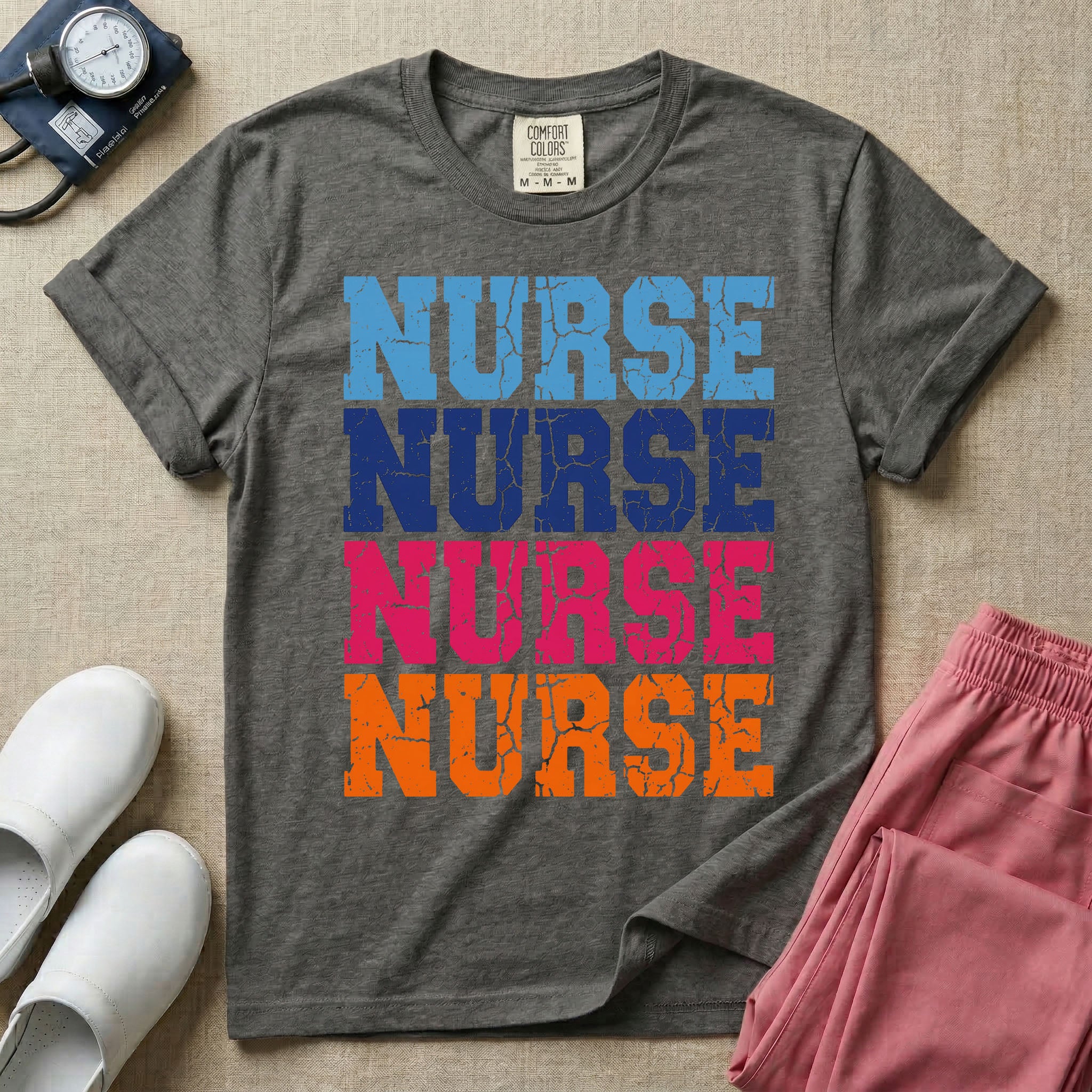 A t-shirt featuring the word NURSE repeated four times in a stacked vertical layout with a distressed, vintage texture in blue, navy, pink, and orange colors.