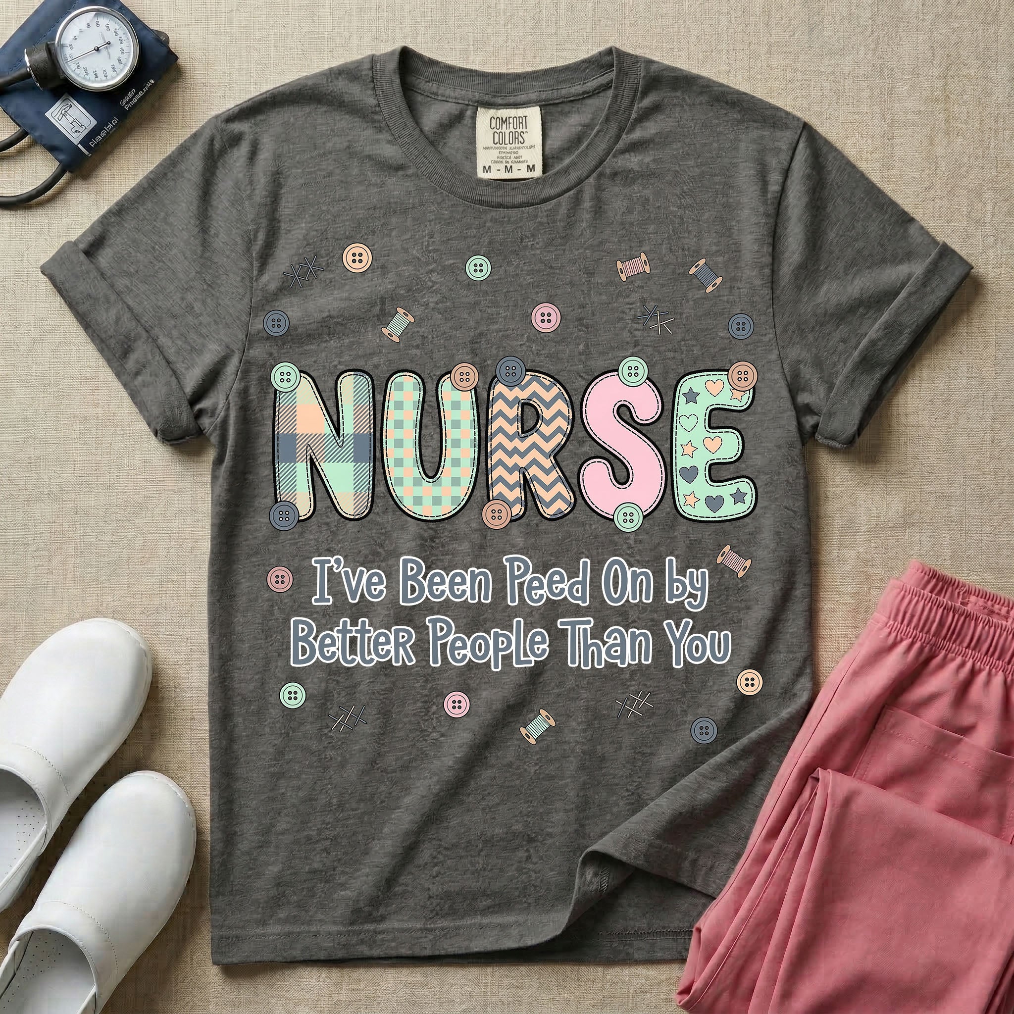 A humorous t-shirt for nurses featuring the word "NURSE" in colorful boho patterned letters above the funny phrase "I've Been Peed On by Better People Than You", surrounded by small abstract floral shapes.