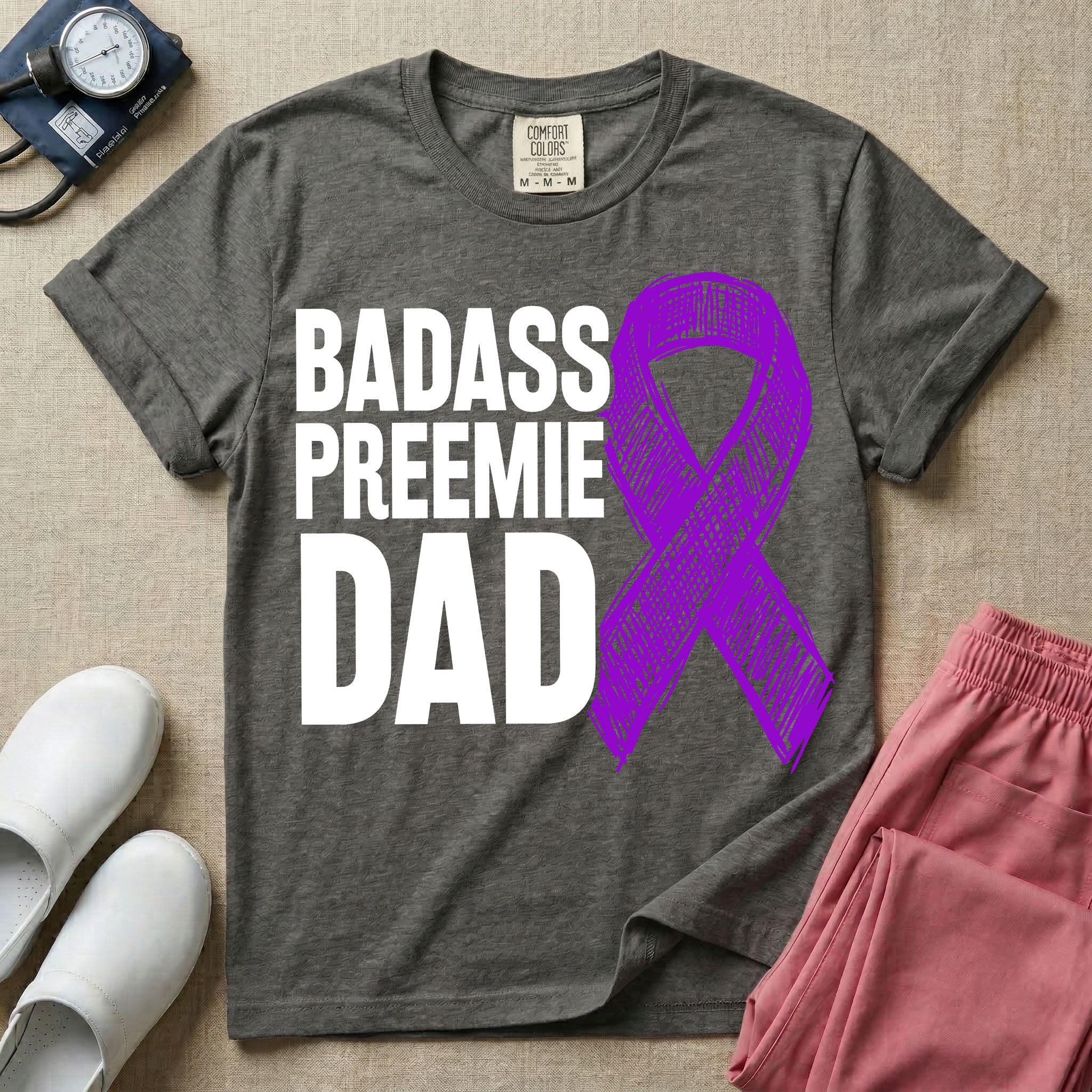A graphic for the Neonatal Intensive Care Unit featuring the stacked, bold white text 'BADASS PREEMIE DAD' next to a large, textured purple awareness ribbon.