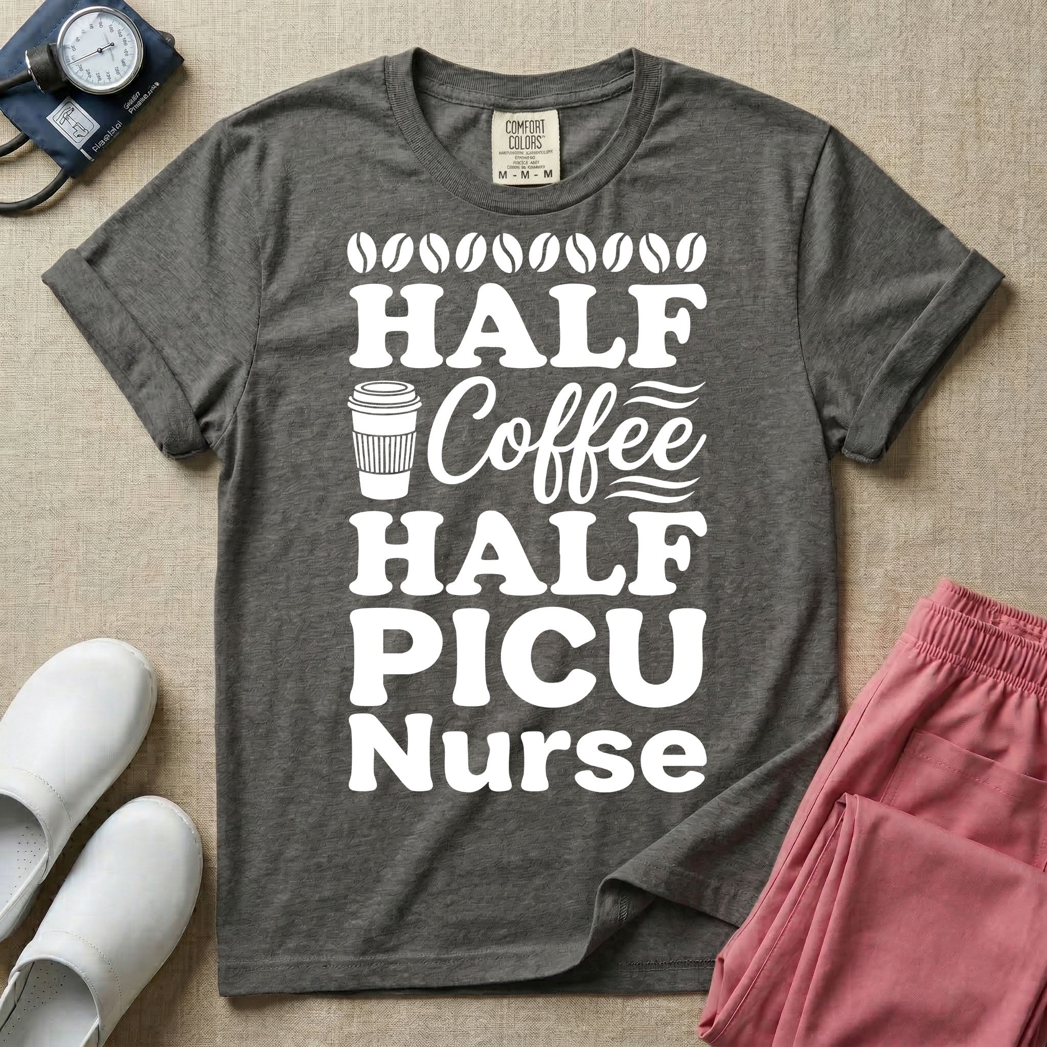 A funny pediatric intensive care nursing t-shirt featuring the stacked white text "HALF COFFEE HALF PICU Nurse" accented with simple graphics of coffee beans and a to-go coffee cup.